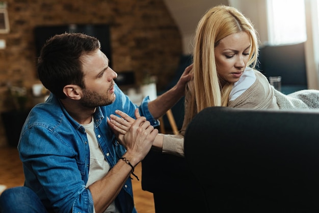 Free photo young displeased couple discussing while having an argument at home.