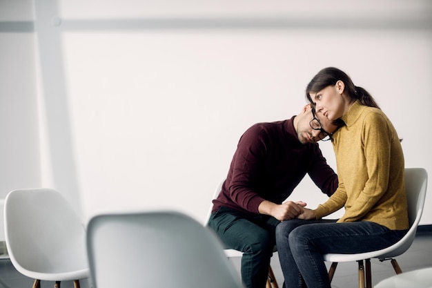 Free photo young distraught couple waiting for a group therapy to start