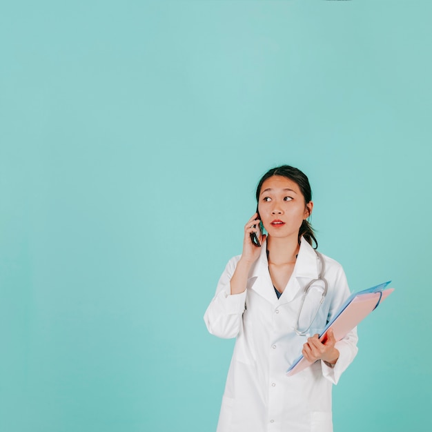 Free Photo young doctor speaking on phone