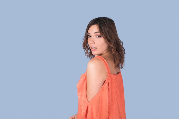 Young elegant lady in orange blouse