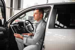 Free photo young elegant man testing a car