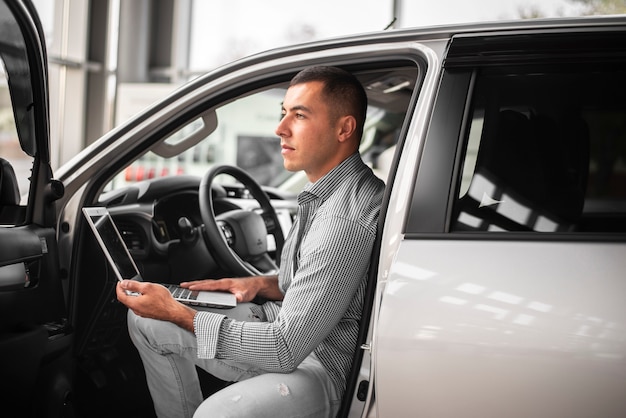 Young elegant man testing a car