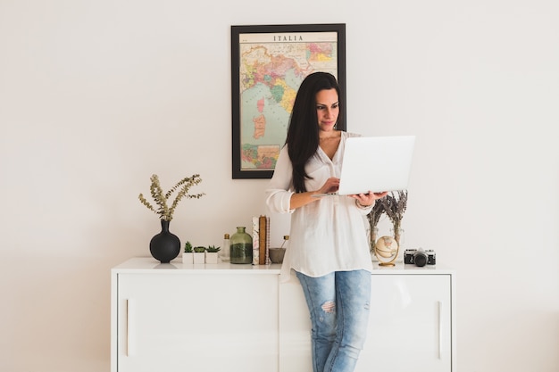 Young employee working next to a white piece of furniture