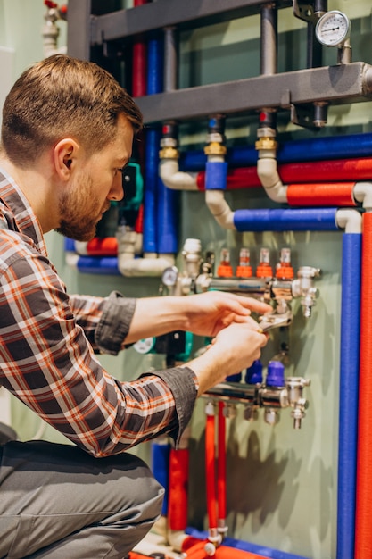 Young engineer adjusting autonomous heating