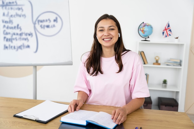 Young english teacher doing her class online