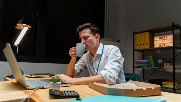 Young entrepreneur enjoying coffee while working