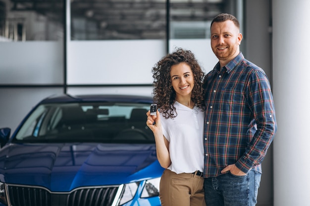 Young family buying a car in a car showroom