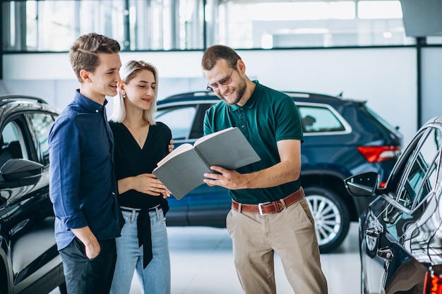 Young family buying a car in a car showroom