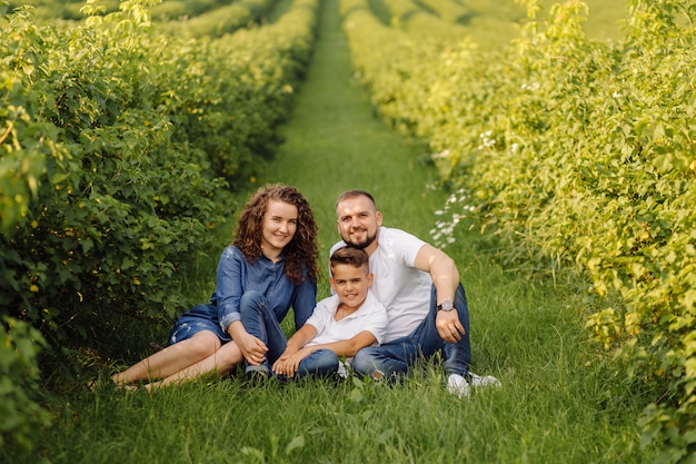 Young family looking while walking in the garden