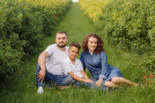 Young family looking while walking in the garden