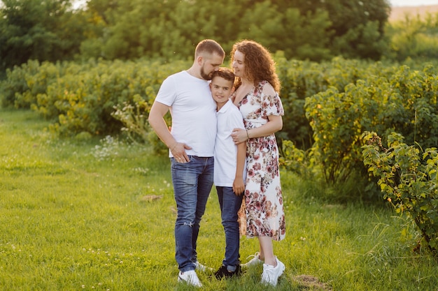 Young family looking while walking in the garden