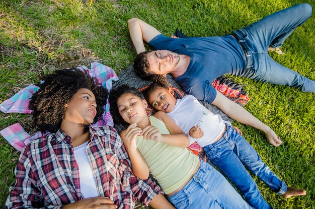 Young family lying on the grass