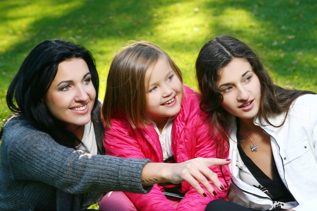 Young family taking healthy stroll through autumn park