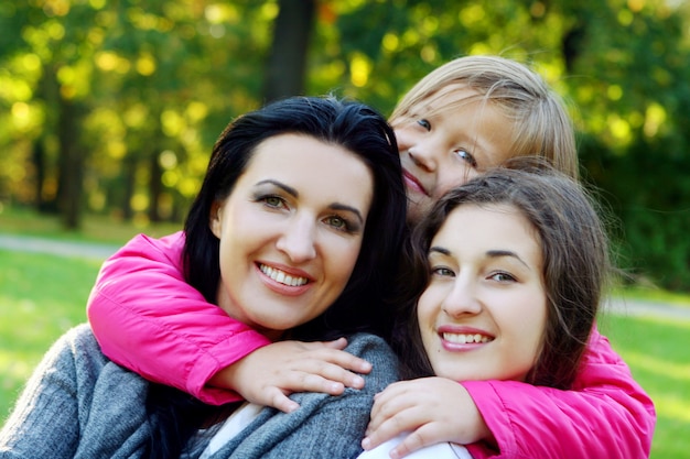 Young family taking healthy stroll through autumn park