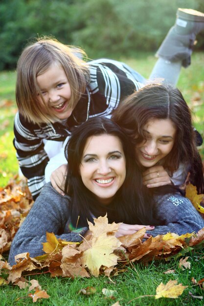 Young family taking healthy stroll through autumn park