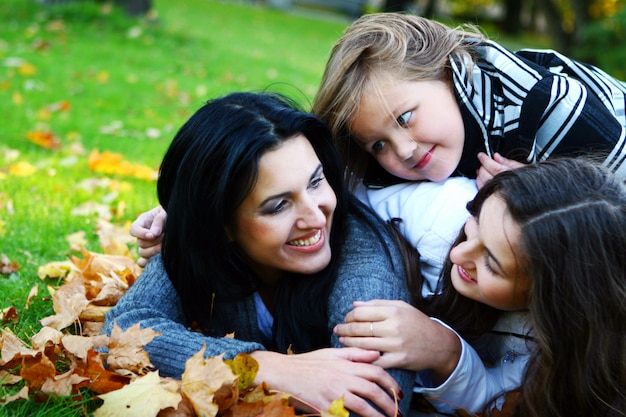 Young family taking healthy stroll through autumn park