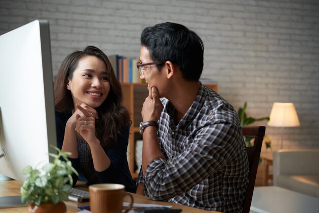 Young family of two discussing online purchases on sale