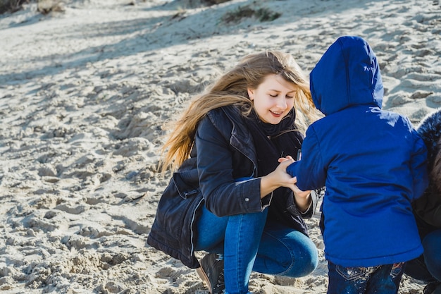 a young family with children spends the weekend on the shores of the cold Baltic sea