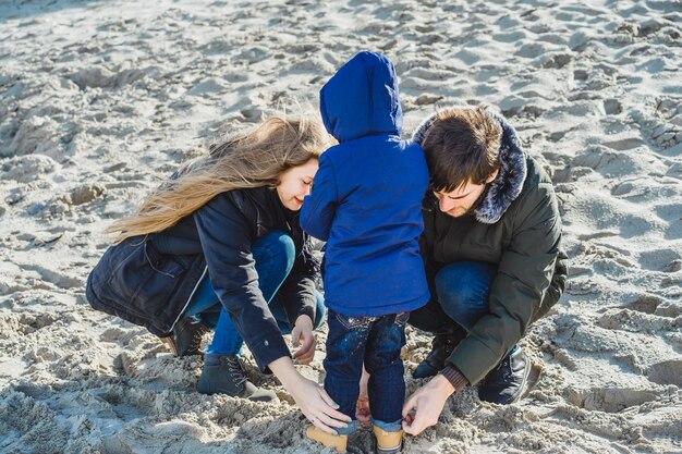 a young family with children spends the weekend on the shores of the cold Baltic sea