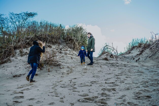 a young family with children spends the weekend on the shores of the cold Baltic sea