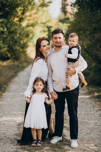 Young family with kids in forest together