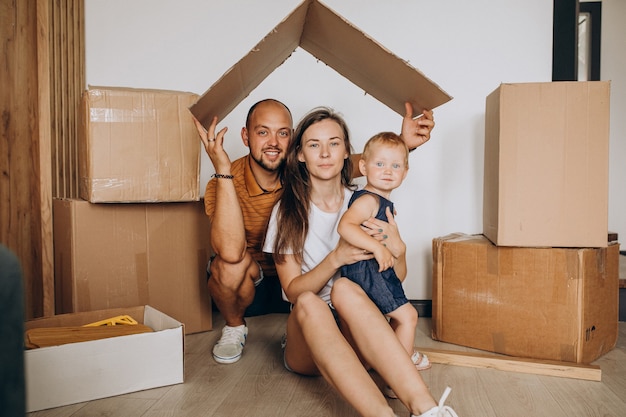 Young family with little daughter moving into new house