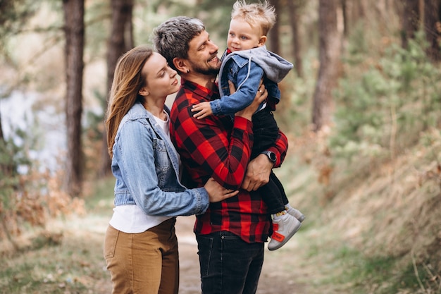 Young family with little son in forest