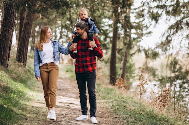 Young family with little son in forest