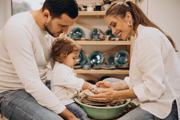 Young family with little son at a pottery class