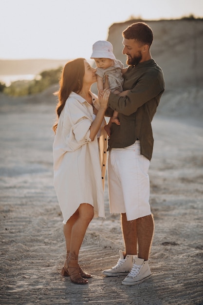 Young family with little son on the sunset