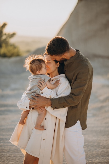 Young family with little son on the sunset