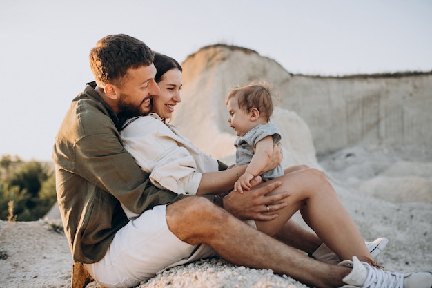 Young family with little son on the sunset