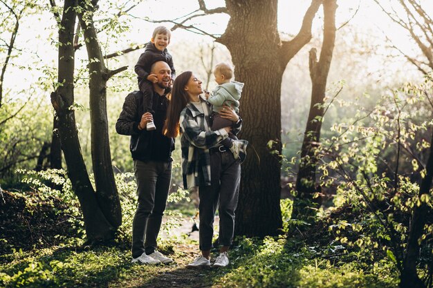 Young family with their kids having fun in the forest