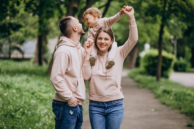 Free photo young family with their little baby child in park