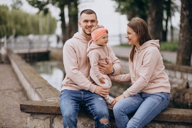 Young family with their little baby child in park