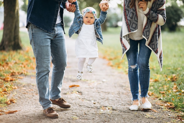 Free photo young family with their small daughter in autumn park