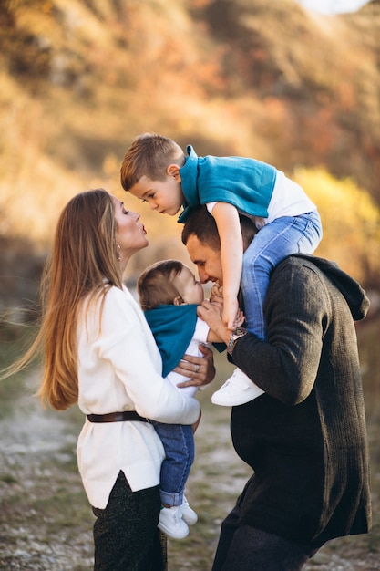 Young family with two sons together outside the park