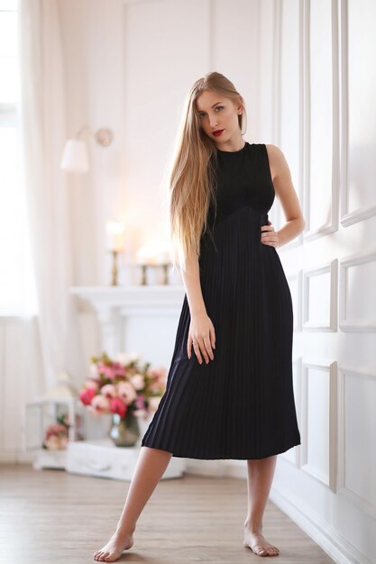 Young fashion woman posing with black dress