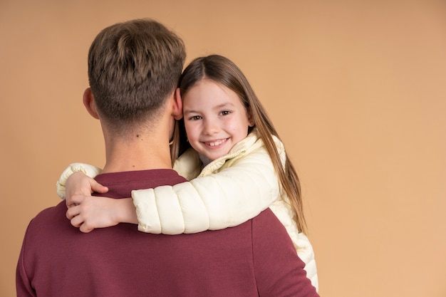 Free photo young father holding daughter before traveling together