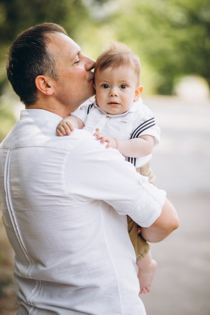 Young father with little son in park