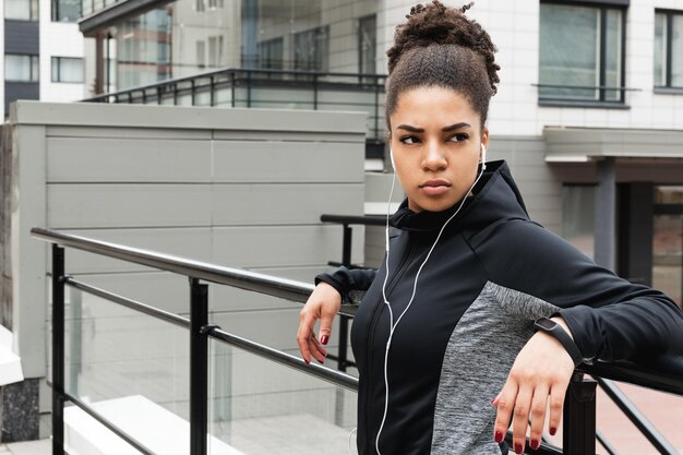 Young female athlete wearing headphones