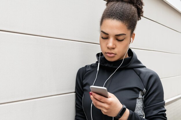 Young female athlete wearing headphones