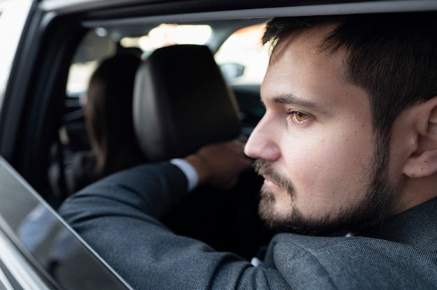 Free photo young female being an uber driver for a male client