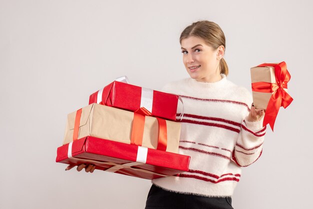 young female carrying xmas presents on white