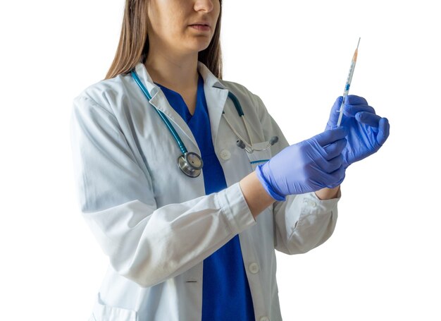 Young female caucasian doctor in a medical uniform and gloves preparing the syringe for an injection