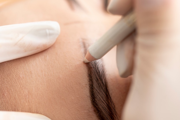 Young female client going through a microblading procedure