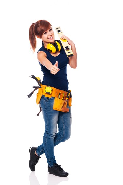 Young female construction worker showing OK sign