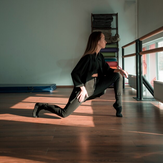 Young female dancer practising in the dance studio