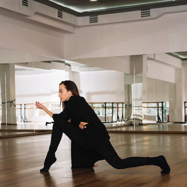 Young female dancer practising in the dance studio