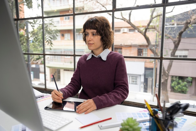 Free photo young female designer working on a project